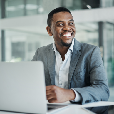 Man smiling at office desk.