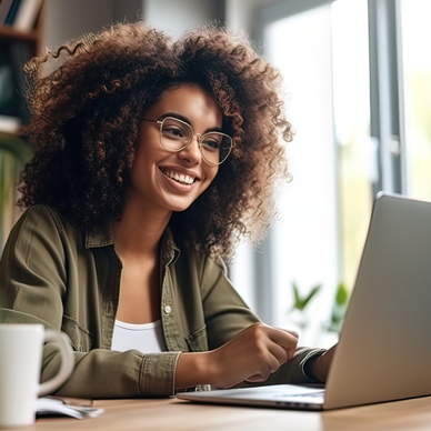 Woman using a laptop at her desk.