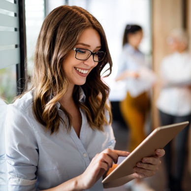 A woman uses a tablet in an office. 