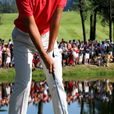 A crowd watches a golfer as they take a swing.