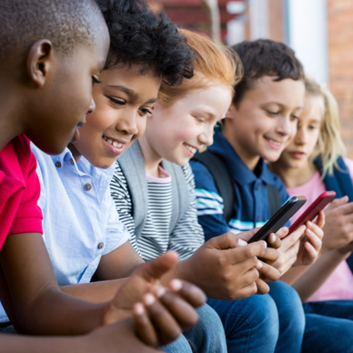 A group of kids watch videos on their iPhones.