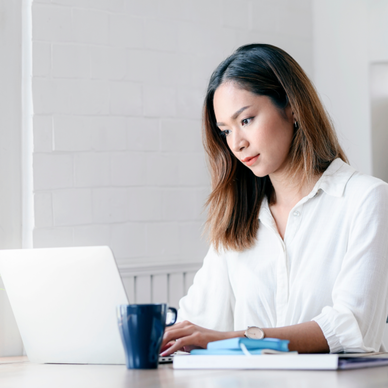 A woman types on her computer. 