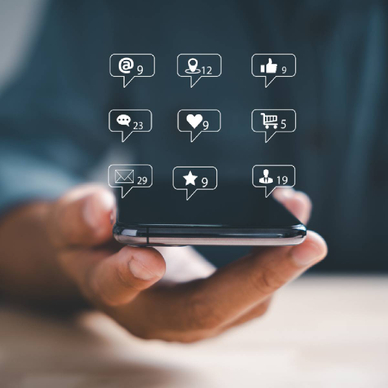 Person holding a smartphone with illustrations depicting mobile popups
