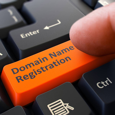 Finger presses orange keyboard button domain name registration
