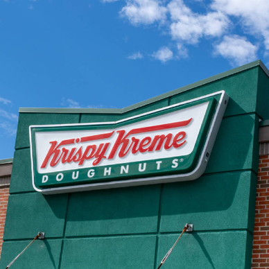 Close up of a Krispy Kreme sign on building