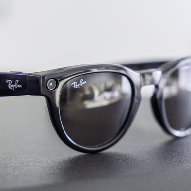 Close-up of black Meta Ray-Ban smart glasses featuring a camera lens.