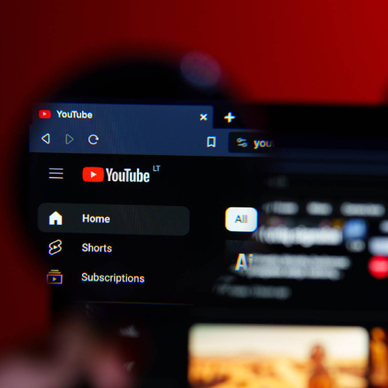 A closeup of a magnifying glass on YouTube desktop