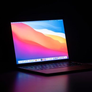 MacBook Air isolated on a desk in the dark.