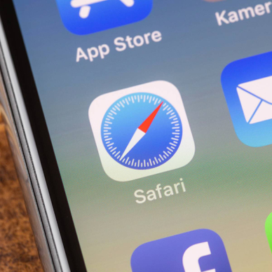 Close up to safari app on the screen of an iPhone X with personalized background