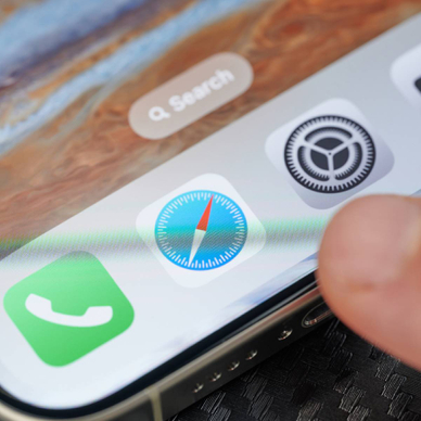 Closeup of person tapping Safari icon on smartphone