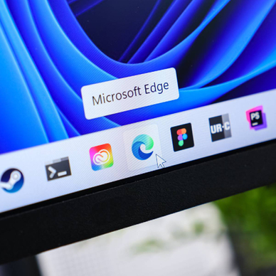 Microsoft Edge browser icon with cursor hovering on taskbar of a modern Windows 11 operating system display, illustrating digital web navigation experience