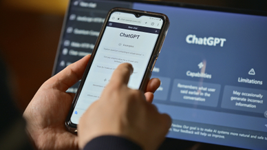 Person using ChatGPT on mobile and laptop