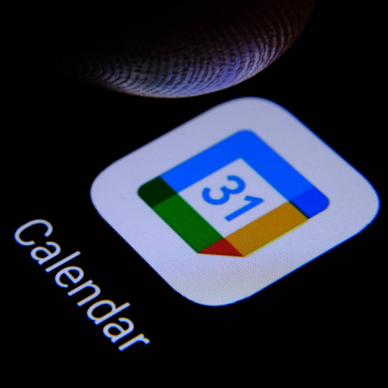 Google calendar app and blurred finger tip above it ready to press the screen of smartphone.