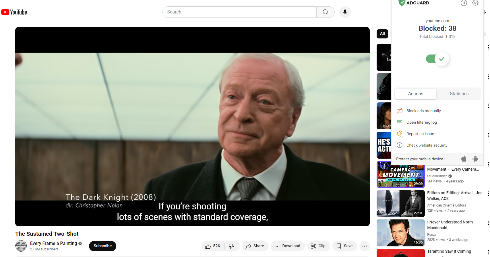 A YouTube video with the AdGuard extension in the foreground