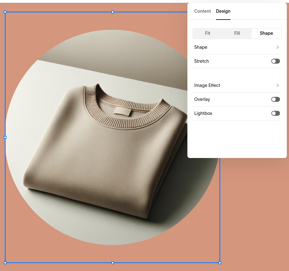 A blue editor rectangle is around an image of a sweater.