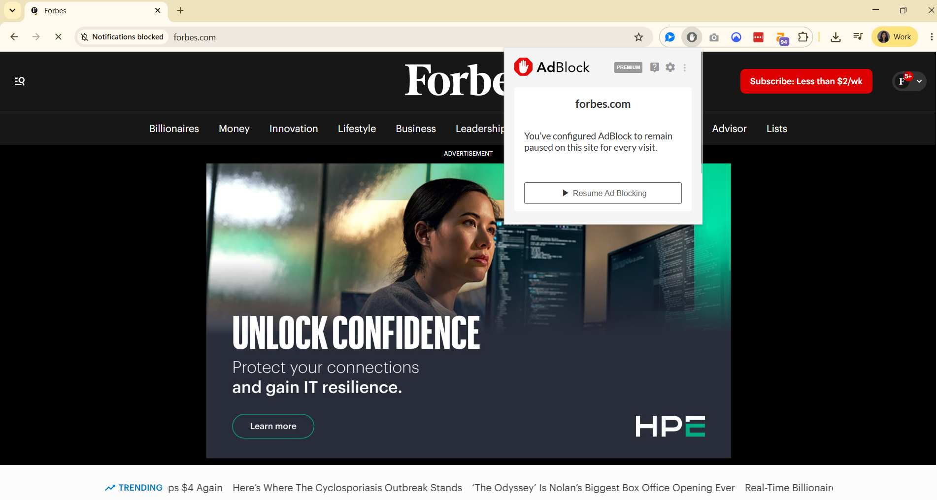 Forbes homepage ad with AdBlock extension open and paused