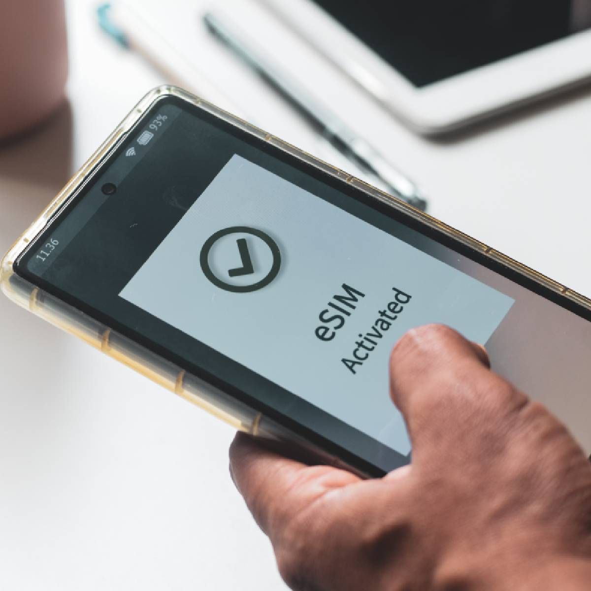 A person&#x27;s mobile phone displaying &quot;eSIM activated&quot;